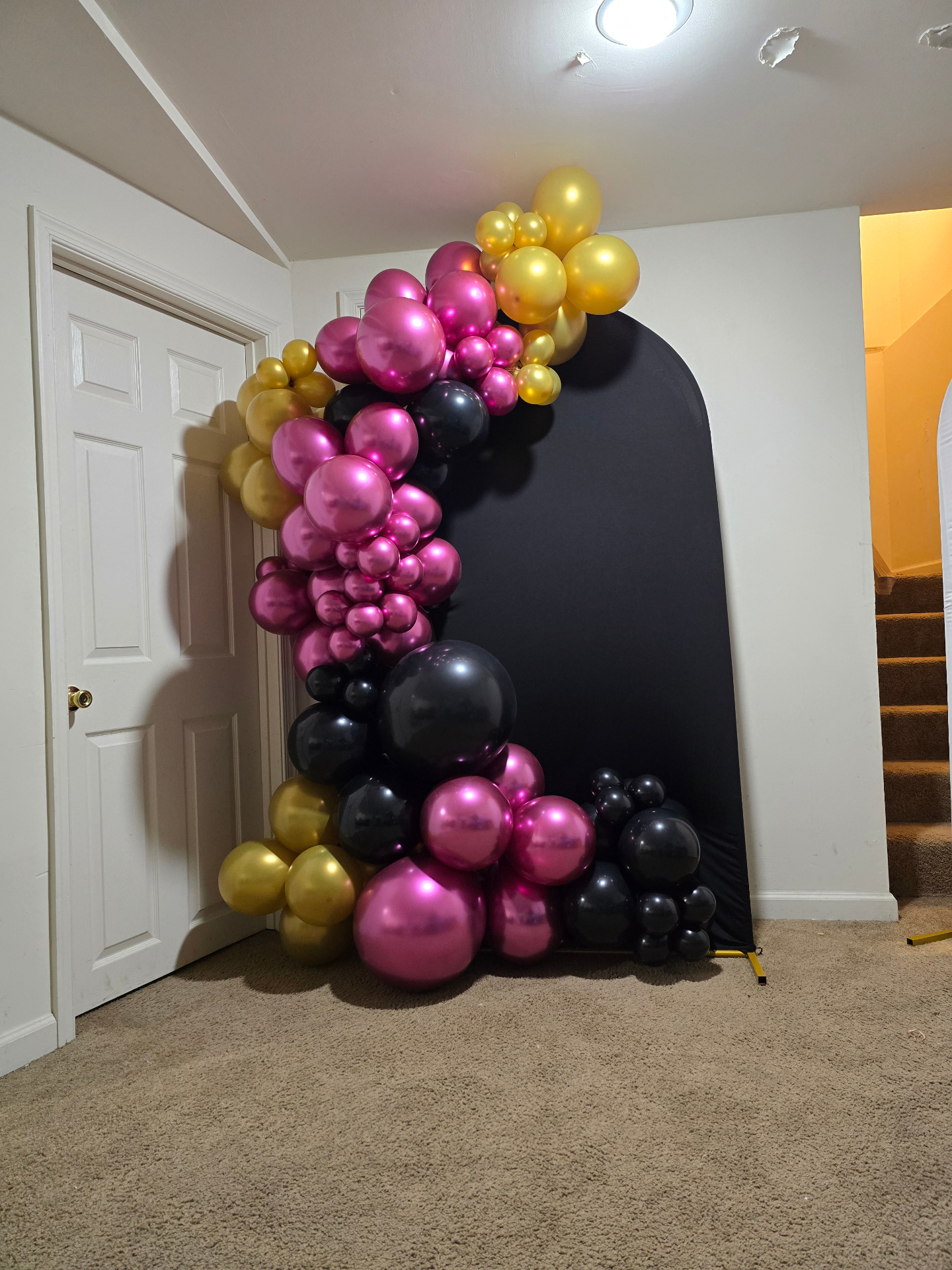 Magenta, gold and black balloon arch installation by Simone's Creations DMV