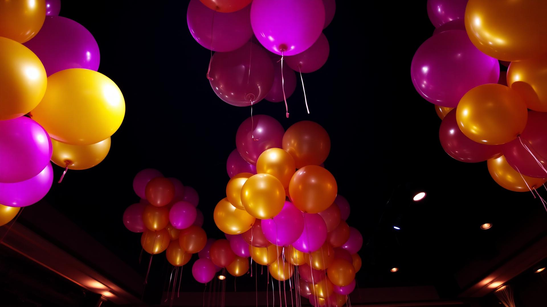 Dramatic luxury balloon installation in berry and gold